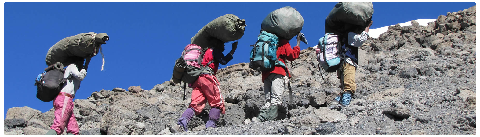 Porters carrying gear up the trail